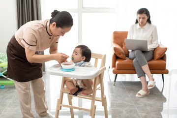 Nanny taking care of baby girl
