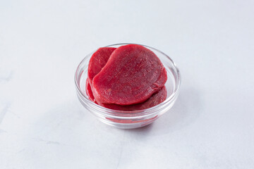 A view of a glass cup of sliced beets.