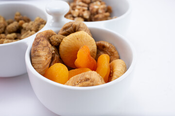 A view of a bowl of dried figs and dried apricots.