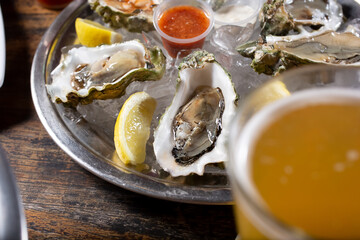 A view of a platter of raw oysters.