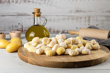 Homemade Italian gnocchi made from potatoes, wheat flour dough, eggs. Raw food, prepare to cook. Copy space for the recipe. 