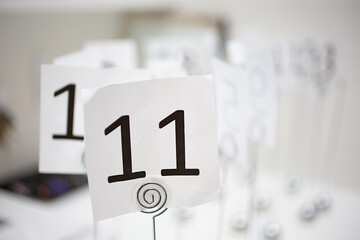 A view of a restaurant number holder on a table, number 11.