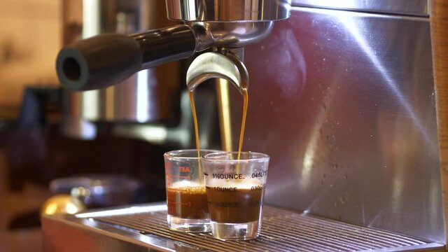 Espresso coffee. Making espresso coffee pouring shots on using 2 spout portafilter on espresso machine Professional