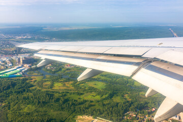 View from the airplane window during taking off on a clear summer morning. Yekaterinburg, Russia