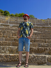 handsome man in a red hat in ephesus ancient city, izmir