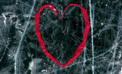 A heart made of fabric lies on the cracked ice of frozen Lake Baikal. Olkhon Island