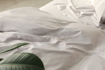 Obraz premium Bed with stylish silky linens in room