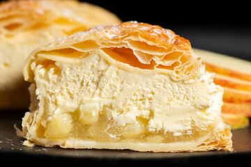 Flaky sweet puff pastry turnover with diced apple and fresh whipped cream