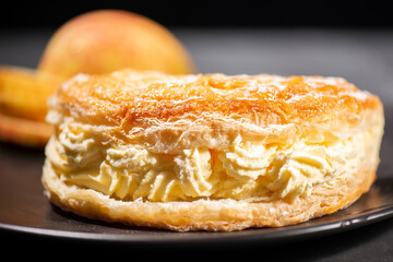 Flaky sweet puff pastry turnover with diced apple and fresh whipped cream