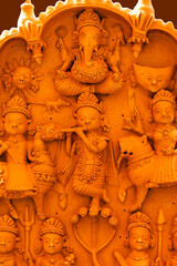Pune , 11 December 2021: Terracotta tiled artwork at Handicraft Fair in Pune. Beautiful terracotta carving hindu Gods figure on the Tile, relief art.