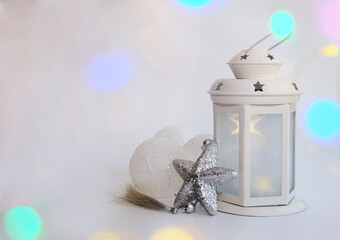 A lamp, Christmas balls, and a star on a red background, a layout with a copy space.