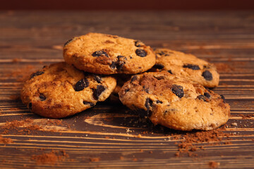 Tasty chocolate chips cookies on wooden table