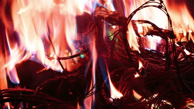 wires on fire. Firing winding insulation of electrical wiring in the fire in the winter woods