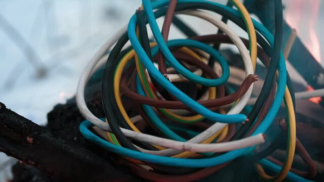 wires on fire. Firing winding insulation of electrical wiring in the fire in the winter woods