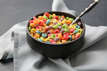 Bowl of colorful cereal rings on dark background - Powered by Adobe