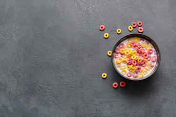 Bowl of colorful cereal rings on dark background