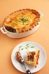 Tasty beef pot pie on color background