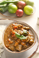 Plate with tasty beef curry on table, closeup