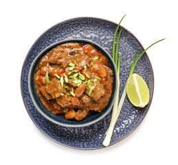 Plate with tasty beef curry on white background
