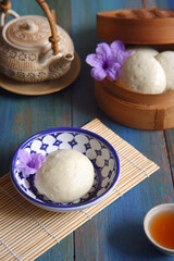 Fototapeta na wymiar steamed bun named bao zi or bapao in a patterned plate 