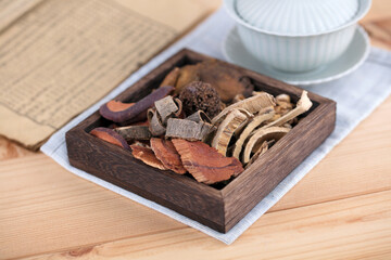 The wooden box is filled with traditional Chinese medicine and medicine books and tureen