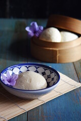 steamed bun named bao zi or bapao in a patterned plate 
