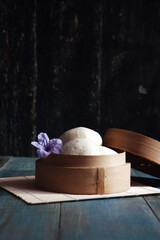 steamed bun named bao zi or bapao in a patterned plate 