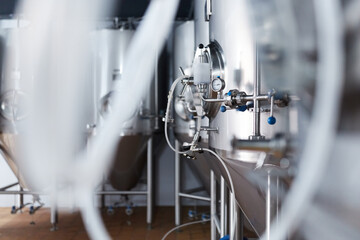 Equipment for the production of craft beer, containers for fermentation in the climatic chamber, pressure gauge with tubes and stainless steel tanks.
