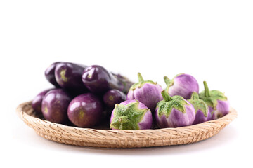 Fresh organic Thai purple eggplant in small basket on white background, Food ingredient
