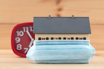 A model house with a mask and an alarm clock

