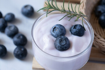 Fresh blueberry yogurt in a clear glass
