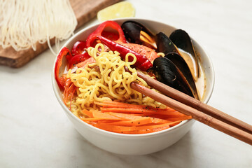 Bowl of spicy Thai soup on table