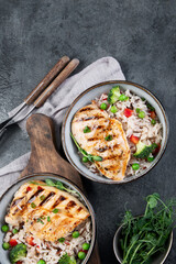 Grilled chicken with vegetables and rice.