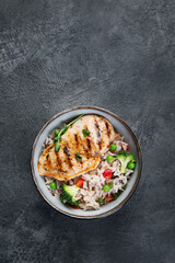 Grilled chicken with vegetables and rice.