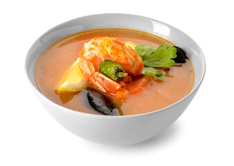 Bowl of spicy Thai soup on white background