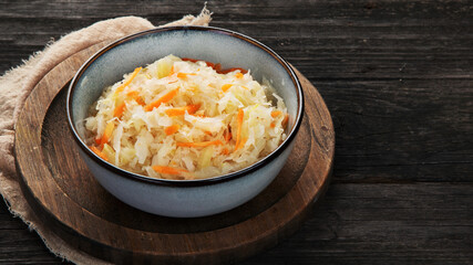 Sauerkraut on wooden background.