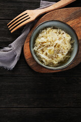 Sauerkraut on wooden background.