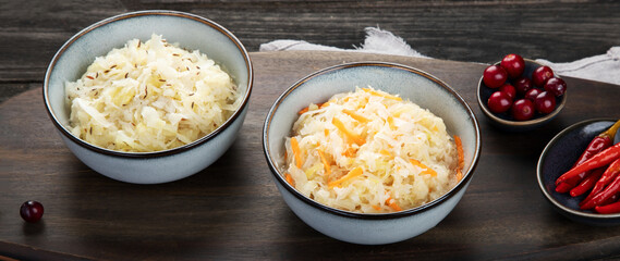 Sauerkraut on wooden background.