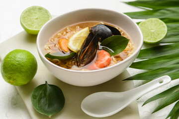 Bowl of spicy Thai soup on table