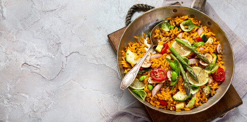 Vegan Paella on gray background.