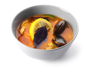 Bowl of spicy Thai soup on white background