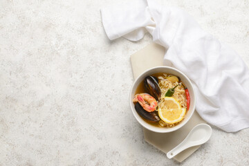 Bowl of spicy Thai soup on grunge background