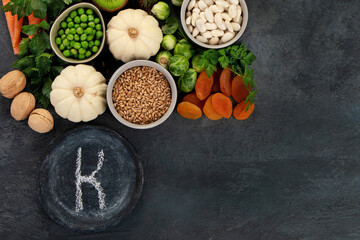 Obraz na płótnie Canvas Foods high in vitamin K on dark background.
