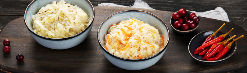 Sauerkraut on wooden background.