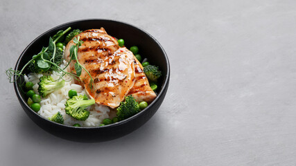 Grilled chicken with green vegetables and rice.