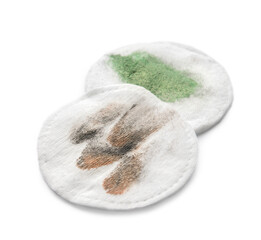 Dirty cotton pads after removing makeup on white background