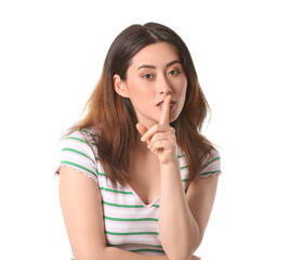 Young Asian woman showing silence gesture on white background