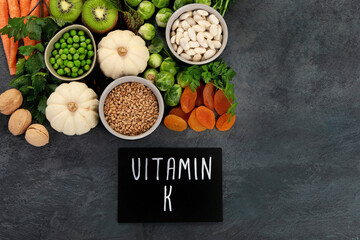 Foods high in vitamin K on dark background.