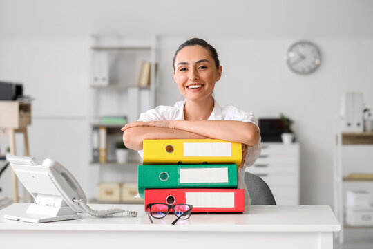 Young woman working with documents in office