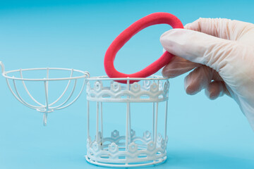 A hand in a medical glove places the omicron virus in a cage. The concept of victory over the coronavirus variant. Omicron is defeated and under control. Vaccination or medication.